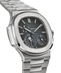 A profile view of the stainless steel Nautilus case, highlighting its distinctive porthole-inspired design with two prominent hinges and the integrated bracelet flowing seamlessly from the lugs.