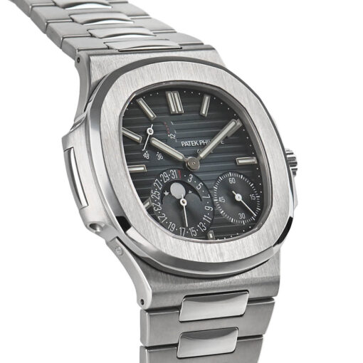 A profile view of the stainless steel Nautilus case, highlighting its distinctive porthole-inspired design with two prominent hinges and the integrated bracelet flowing seamlessly from the lugs.