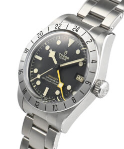 A close-up profile view of the watch's right side, highlighting the satin-brushed case and the prominent screw-down crown with a black anodized aluminum tube, ensuring 200-meter water resistance.