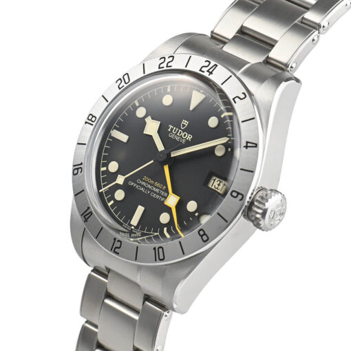 A close-up profile view of the watch's right side, highlighting the satin-brushed case and the prominent screw-down crown with a black anodized aluminum tube, ensuring 200-meter water resistance.