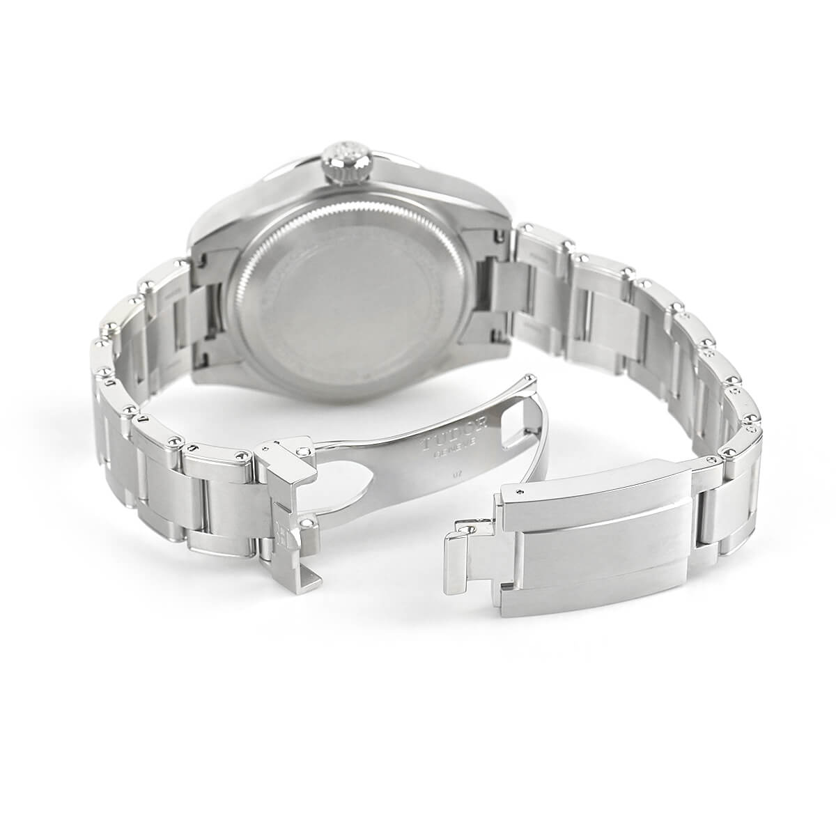 A view of the solid stainless steel case back, featuring detailed engraved text specifying the model, water resistance, and serial number, with the Tudor rose logo prominently centered.